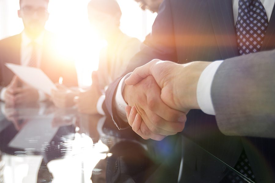 About Our Agency - Closeup of Handshake Between Business Partners in the W. J. Halteman Insurance, LLC Conference Room